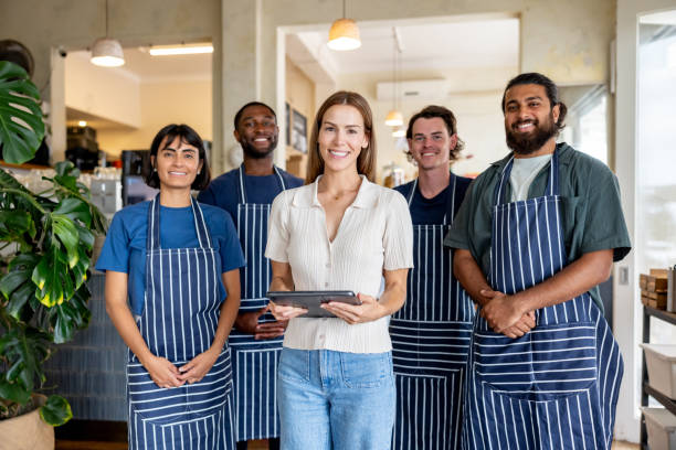 istock Cafe manager smiling with a team of employees 2196056537