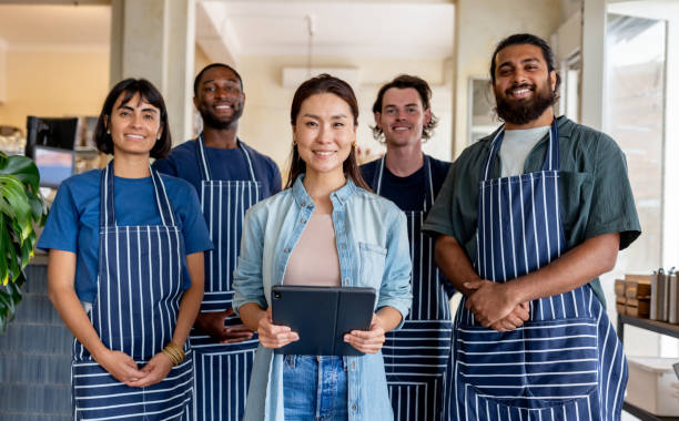 istock Cafe owner smiling with her wait staff 2196056540