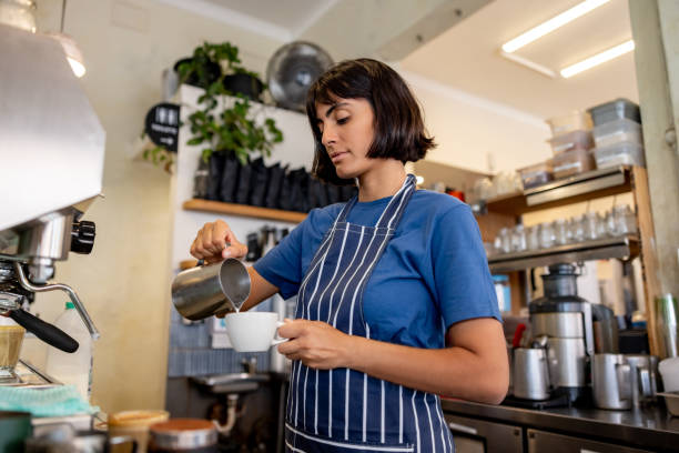 istock Barista making a cup of coffee at a cafe 2196056541