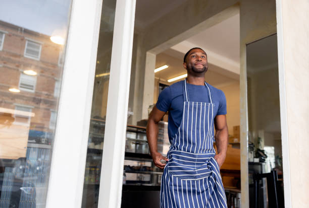 istock Waiter waiting for clients while working at a coffee shop 2196056554