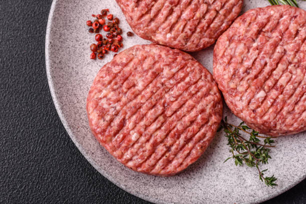 istock Fresh raw ground beef burger patty with salt and spices 2196056581