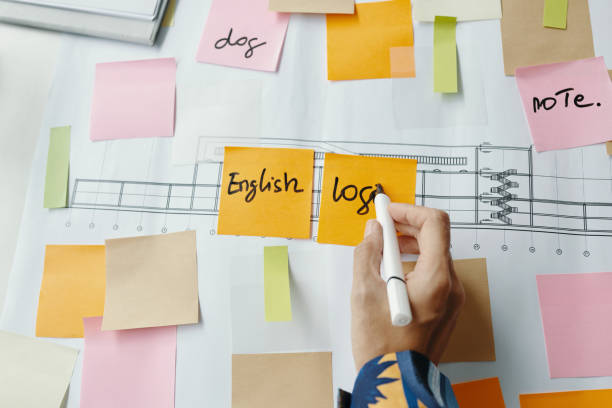 istock Female Hand Writing On Sticky Notes In Office 2196057836