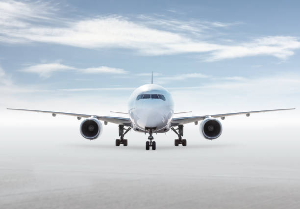 istock Front view of wide body passenger plane isolated on bright background with sky 2196060145