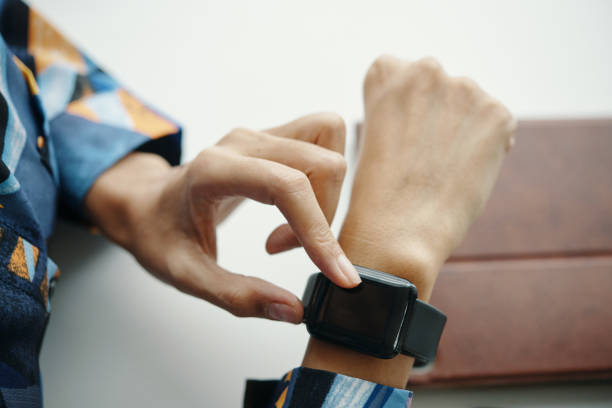 istock Hands Of Young Woman Using Smart Watch 2196062310