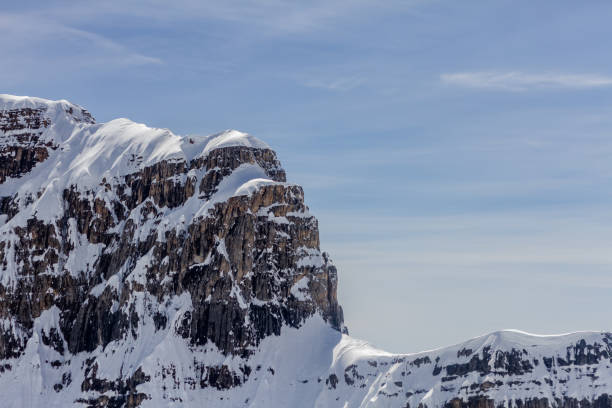 Helicopter aerial view of Mount Assiniboine in Canadian Rocky Mountains.  The highest peak in the Southern Continental Great Divide at 3918 meters tall. \nCoordinants:  50 degrees 52’10”N and 115 degrees 39’03”W, near Canmore, Alberta
