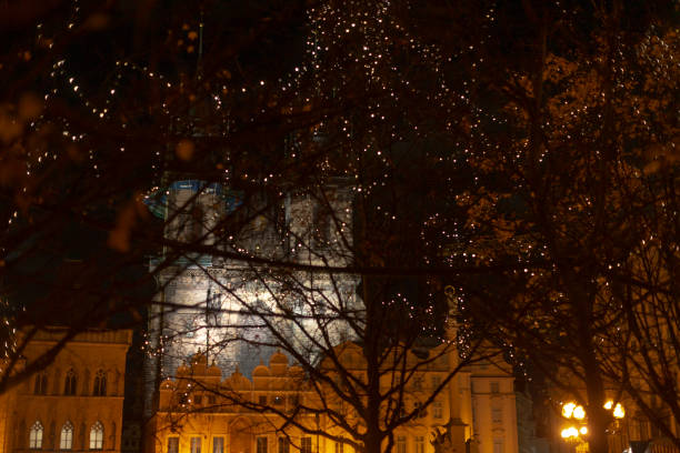 The breathtaking night view showcases a beautifully illuminated structure nestled among trees adorned with festive lights, perfectly capturing the enchanting ambiance of the urban landscape