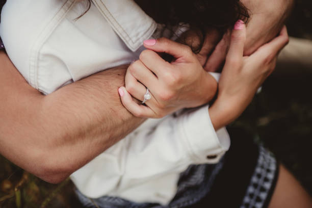 istock Engaged couple excited showing off diamond engagement ring 2196066397