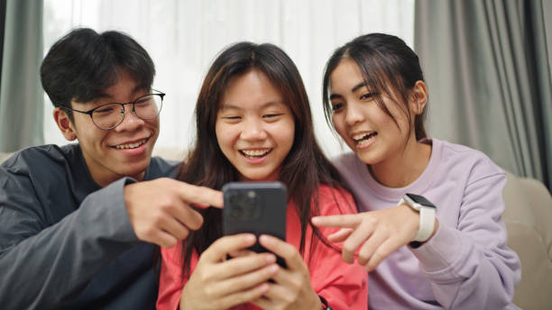 istock Teenagers using smartphone together. 2196067412