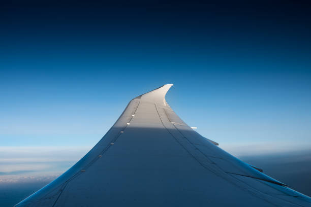 Plane Window Seat View in Flight and Blue Sky
