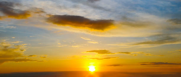 istock Cloudy sky and bright sunrise over the horizon. 2196070036