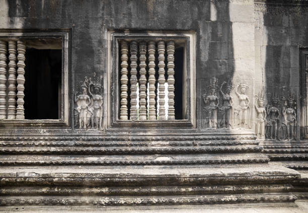 Angkor Wat, Cambodia - 2010, August 8 : An antique temple wall with bas relief sculptures of female devatas and apsaras in the Angkor Wat temple complex in Siem Reap, Cambodia