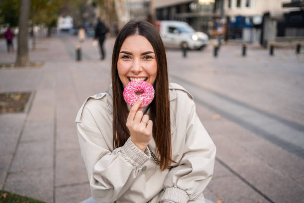 istock Woman enjoying eating a donut 2196072086