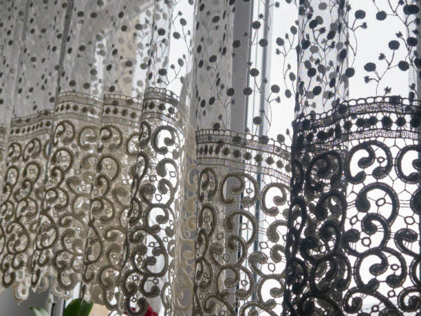 istock Elegant lace curtains gently hanging by the window, creating a delicate and airy atmosphere in a cozy interior 2196072095