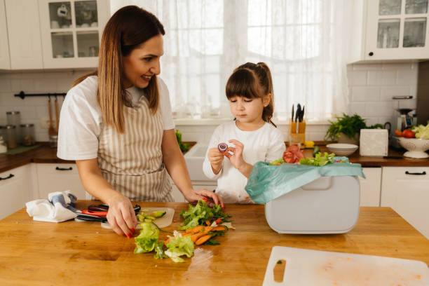 istock Mother and Daughter Practicing Eco-Friendly Kitchen Habits 2196072153