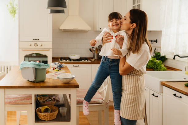 istock Mother and Daughter Practicing Eco-Friendly Kitchen Habits 2196072183