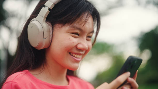 istock Young woman using smartphone outdoors. 2196072625