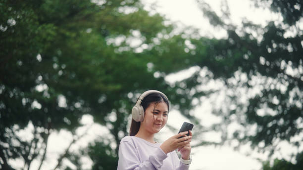 istock Young woman using smartphone outdoors. 2196072626