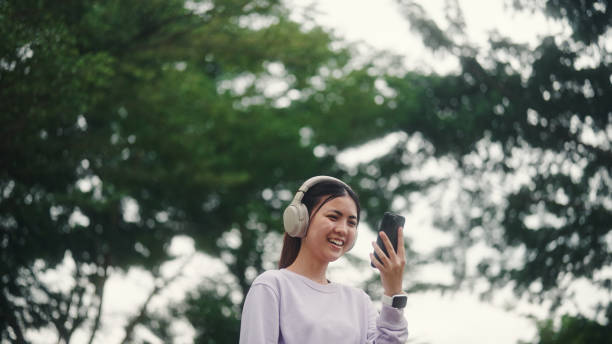 istock Young woman using smartphone outdoors. 2196072639