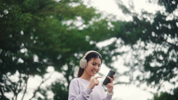 istock Young woman using smartphone outdoors. 2196072655