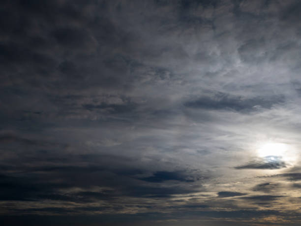 Dramatic sky filled with clouds, showcasing a unique interplay of light and shadow. The scene evokes a sense of wonder and tranquility.