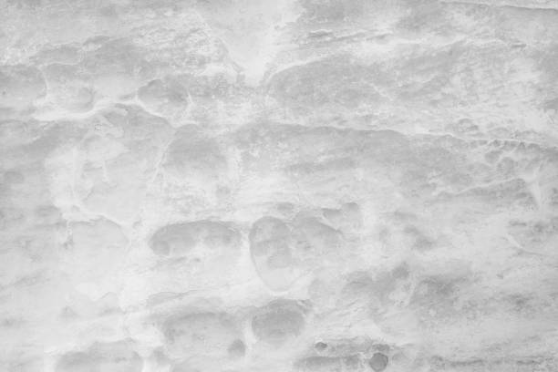 Light grey stone wall background.Black and white rock with groove surface. Monochrome abstract pattern. Natural backdrop. Natural rock texture. Element, material design.