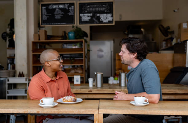 istock Happy couple drinking a cup of coffee at a cafe 2196076652