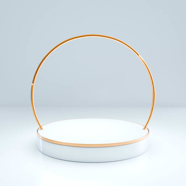 istock 3D White circular platform with gold rim centered beneath gold semi-circular frame, soft gray background. Minimalist, elegant scene emphasizing shape and form. 2196077289
