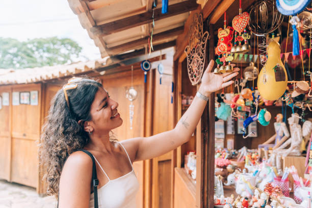 istock Young woman at souvenir kiosk 2196078718