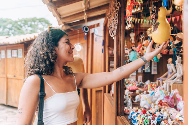 istock Young woman at souvenir kiosk 2196078727