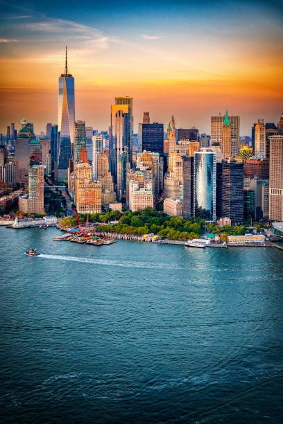The iconic skyline of downtown Manhattan, New York City shot via helicopter from an altitude of about 500 feet over NY Harbor.