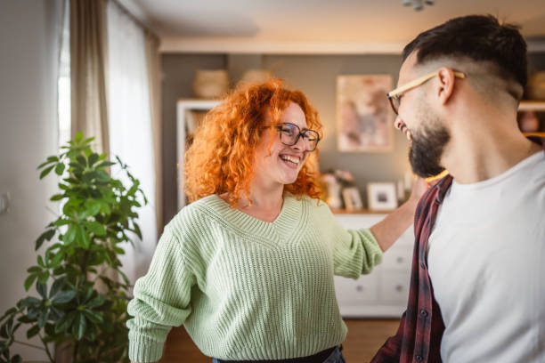 istock joyful positive young married couple have fun at home, dance disco 2196080302