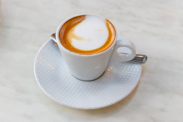 istock Cup of hot cappuccino coffee on a table 2196080740