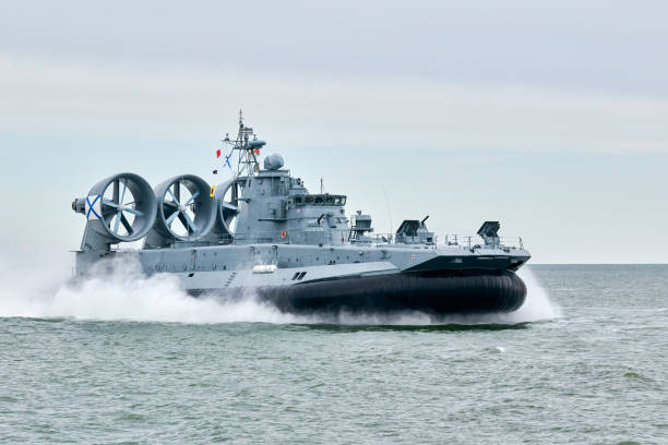 istock Hovercraft warship armed with armament sails into sea toward military target to attack and destroy 2196086164