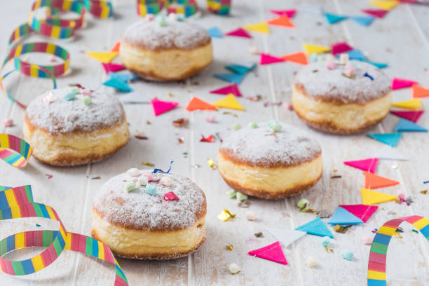 istock Krapfen, Berliner or donuts with streamers, confetti and mini marshmallows 2196086976