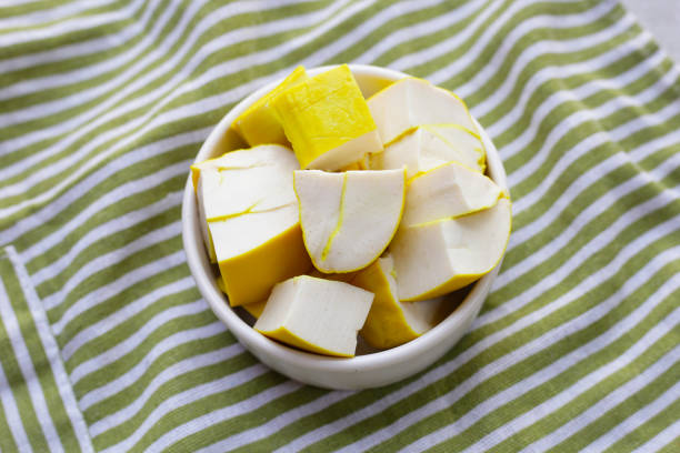 Delicious ripe mango with green on white.