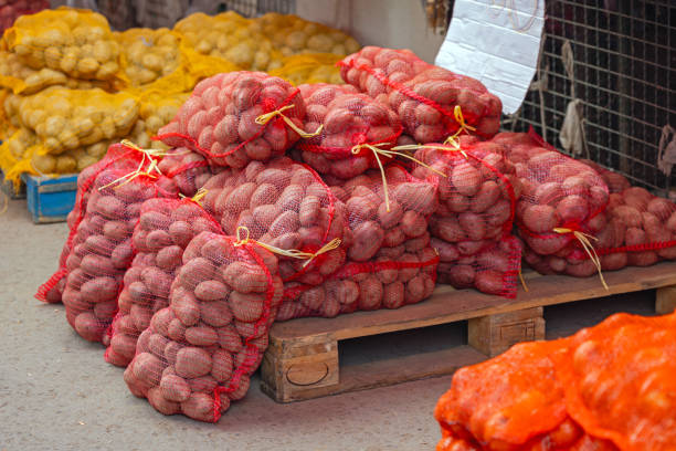Pallet of Potatoes in Sacks at Farmers Market Autumn Day