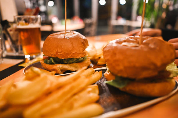 istock burgers on table at restaurant. 2196100790