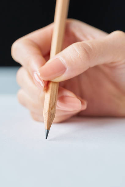 istock Hand holding a pencil and blank paper 2196102688