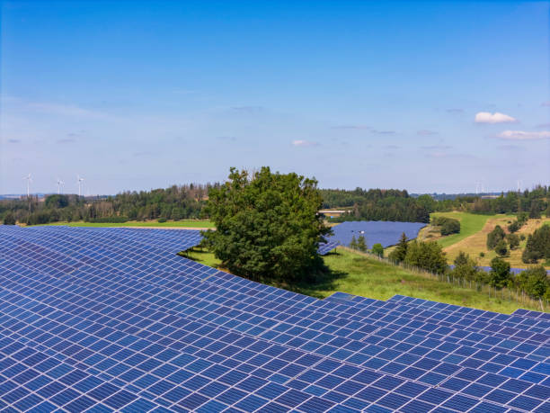 istock modern solar panels and wind turbines in a rural landscape 2196103292