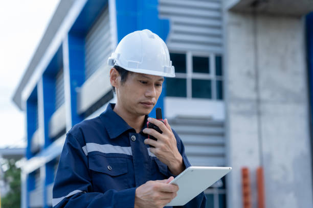 istock maintenance and inspector. Maintenance engineers are using tablet to checking results of inspection of buildings and structures. Irrigation engineers are exploring sluice systems 2196104665