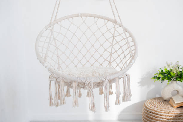 istock Cozy hanging chair in modern living room with decorative elements 2196106664