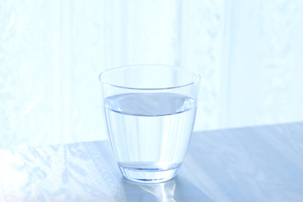 istock glass cup of water on a wooden table 2196108671