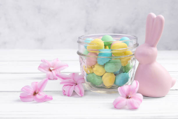 istock Easter bunny, jar with sweet eggs and hyacinth flowers. 2196110219