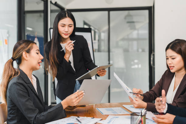 istock Empowered women collaborate in modern office, discussing strategies and analyzing data. Their focused expressions reflect determination and teamwork 2196110269