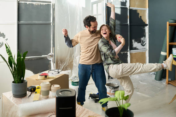 istock Young ecstatic couple dancing at home 2196112639