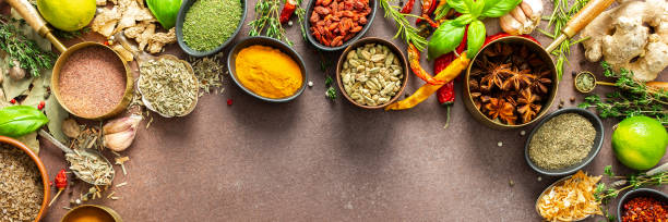 istock A visually striking arrangement of fresh spices and herbs on a brown surface, highlighting their vivid colors, intricate details, and rich culinary essence, banner 2196114362