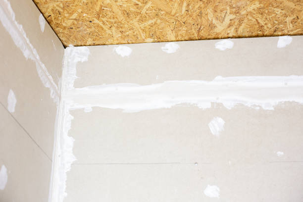 istock Preparing drywall for plastering. A wall in a room with putty-filled joints and screws 2196114522