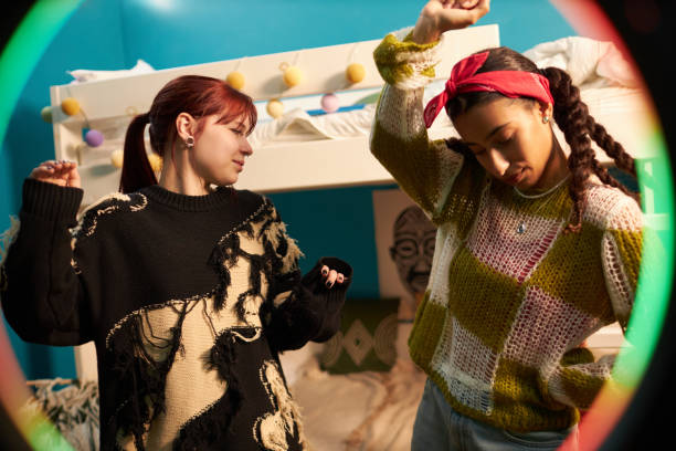 istock Two Girls Dancing While Livestreaming 2196116311