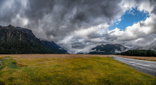 istock Lush green valley and  huge rugged mountain peaks and tall cliffs 2196116435