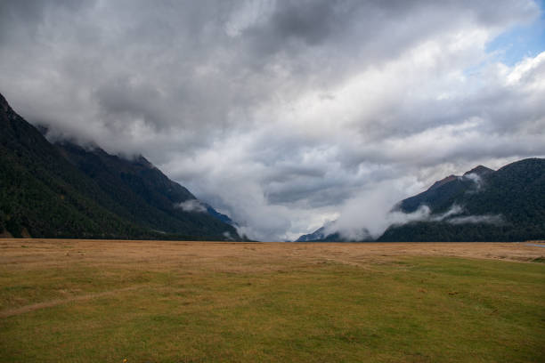 istock Lush green valley and  huge rugged mountain peaks and tall cliffs 2196116438